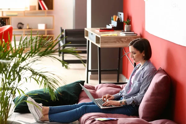 Female designer working with laptop at home — Stock Photo, Image