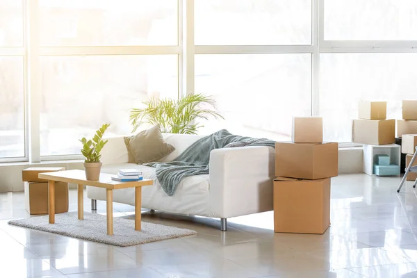 Furniture, belongings and moving boxes in room — Stock Photo, Image