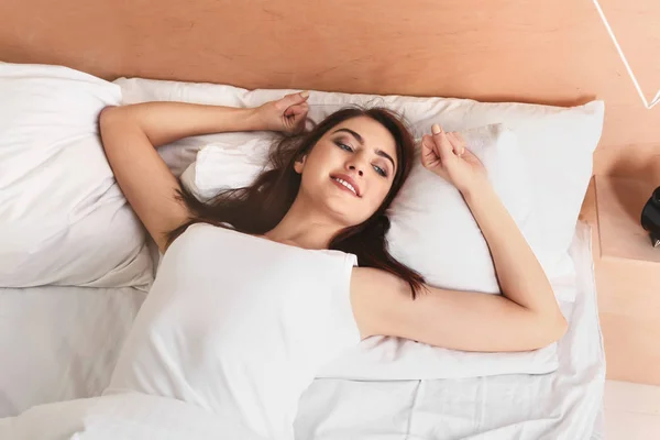 Morning of beautiful young woman lying in bed — Stock Photo, Image