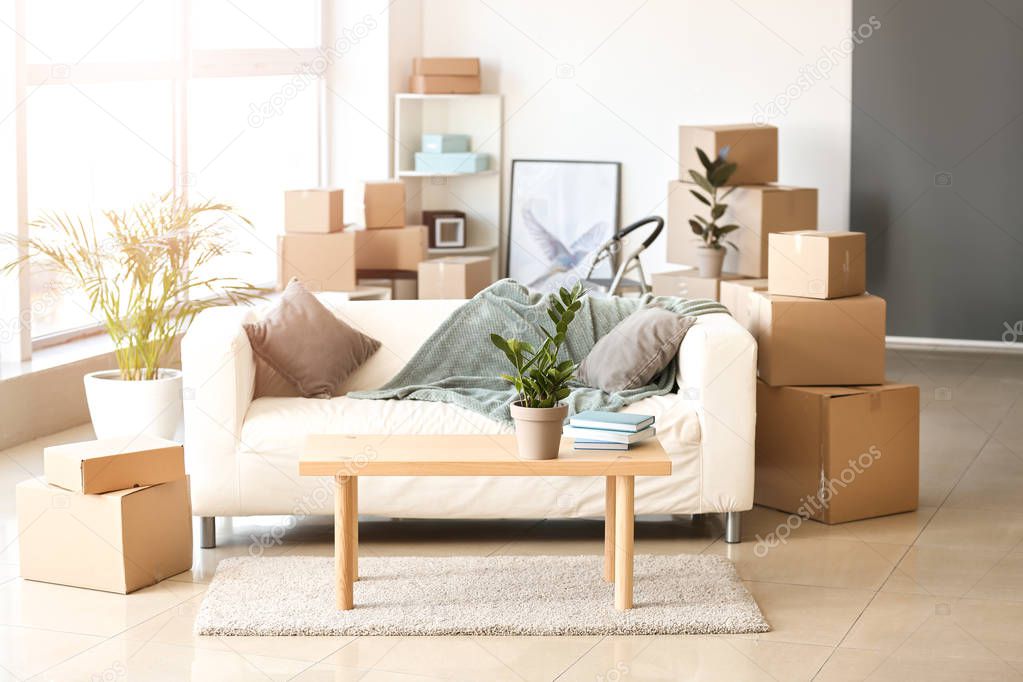 Furniture, belongings and moving boxes in room