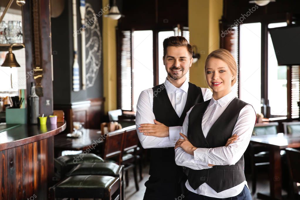 Young waiters in restaurant