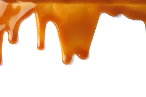 Plamy płyn karmelu na białym tle — Zdjęcie stockowe