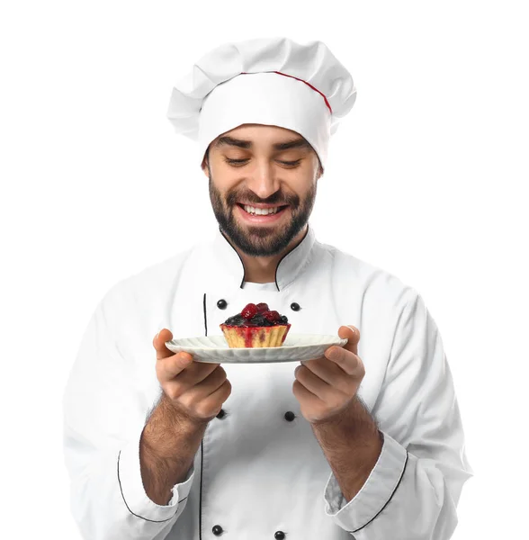Confeiteiro masculino com sobremesa saborosa no fundo branco — Fotografia de Stock