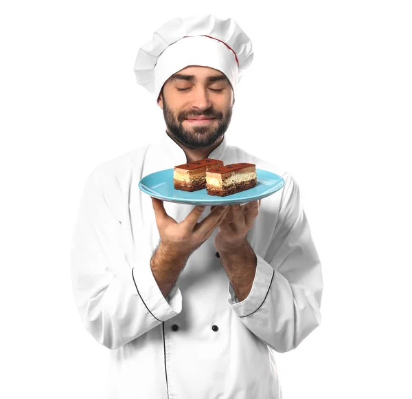 Mannelijke banketbakker met lekkere dessert op witte achtergrond — Stockfoto
