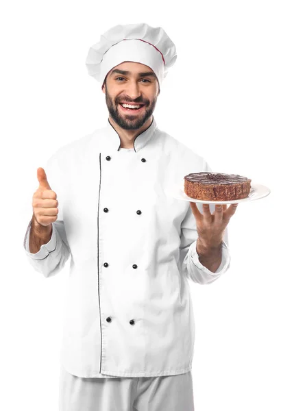 Mężczyzna cukiernik z smaczny deser wyświetlone kciuk na białym tle — Zdjęcie stockowe