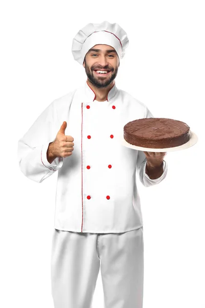 Konditor mit leckerem Dessert zeigt Daumen nach oben auf weißem Hintergrund — Stockfoto