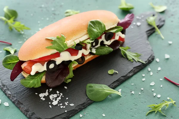 Tasty hot dog on slate board — Stock Photo, Image