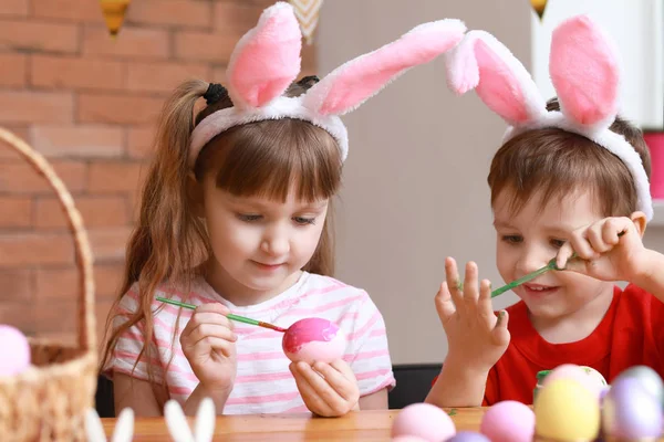 Leuke lieve kinderen thuis paaseieren schilderen — Stockfoto