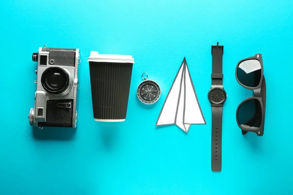 Photo camera, coffee, compass, paper plane, watch and sunglasses on color background. Travel concept — Stock Photo, Image