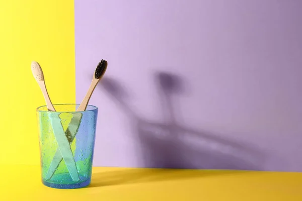 Holder with toothbrushes on color background — Stock Photo, Image