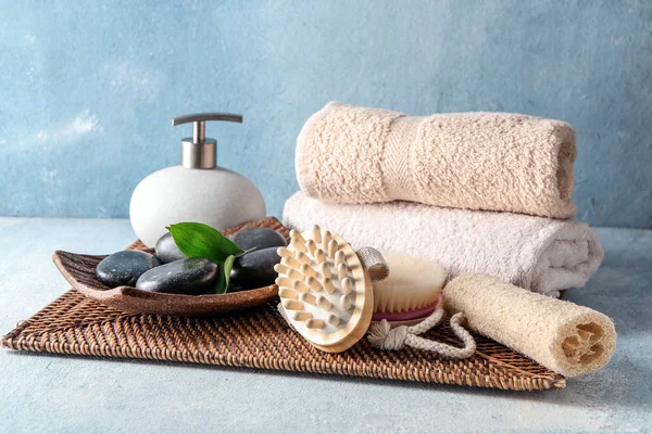 Massage brushes with towels and spa stones on table — Stock Photo, Image