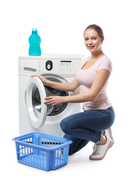 Young woman doing laundry on white background — Stock Photo, Image
