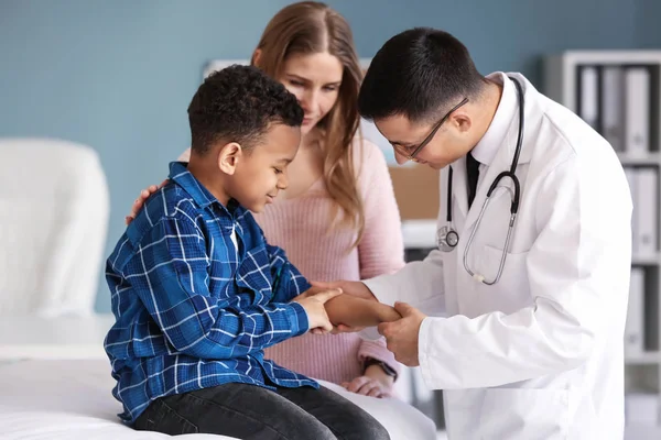 Pediatra examinando niño afroamericano en clínica — Foto de Stock