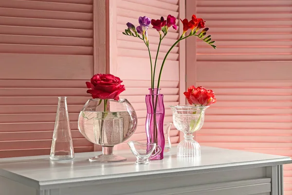 Glass vases with beautiful flowers on table — Stock Photo, Image