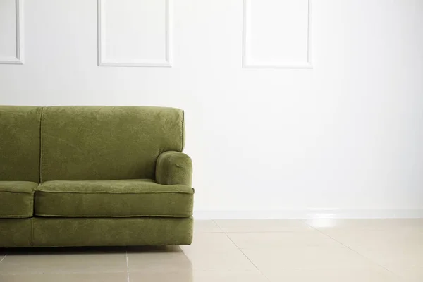 Comfortable sofa near white wall — Stock Photo, Image