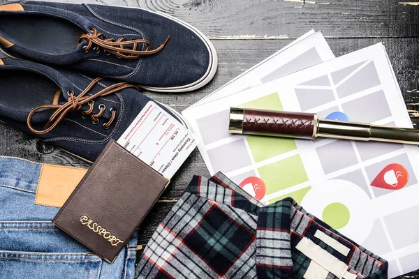 Male clothes with documents, spyglass and map on wooden background — Stock Photo, Image