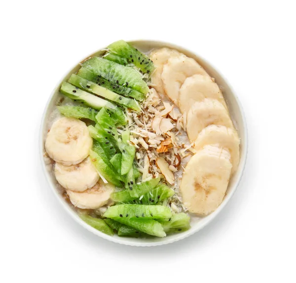 Bowl with tasty sweet oatmeal on white background — Stock Photo, Image