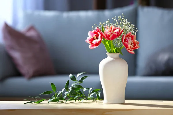 Vase with bouquet of beautiful flowers on table in room — Stock Photo, Image