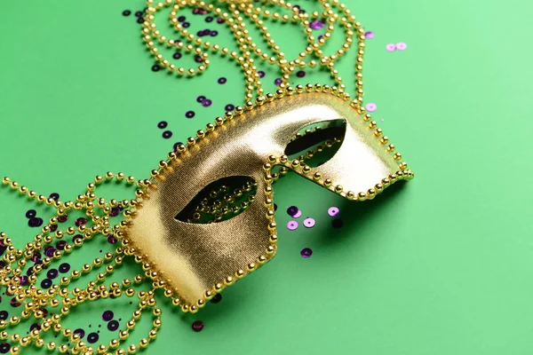 Festive mask with beads on color background — Stock Photo, Image