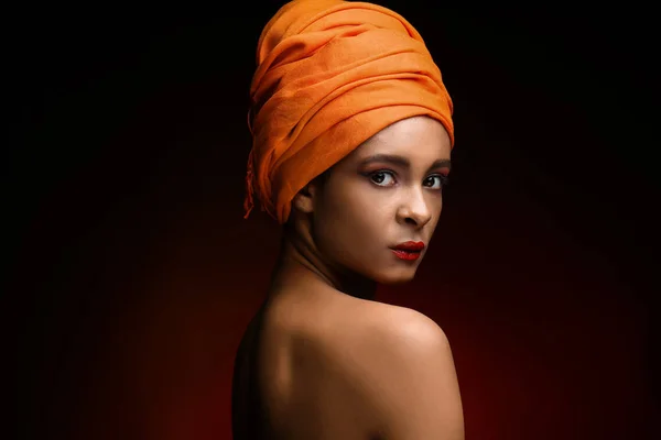 Retrato de bela mulher afro-americana com cachecol na cabeça sobre fundo de cor escura — Fotografia de Stock