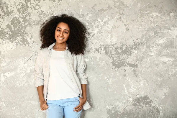 Beautiful African-American woman near light wall — Stock Photo, Image