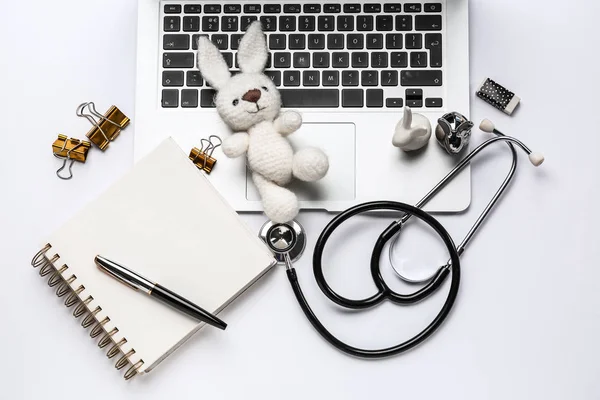 Laptop, stethoscope, stationery and toy on white background — Stock Photo, Image