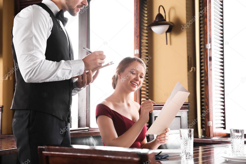 Waiter taking order in restaurant