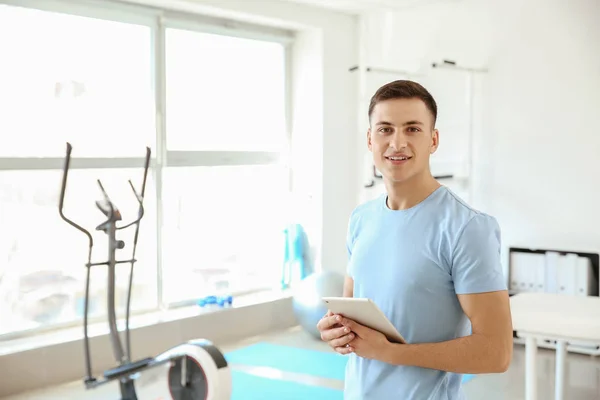 Young male physiotherapist in rehabilitation center — Stock Photo, Image