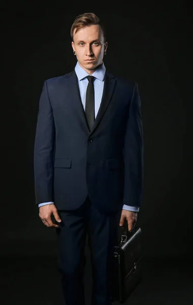 Handsome stylish businessman on dark background — Stock Photo, Image