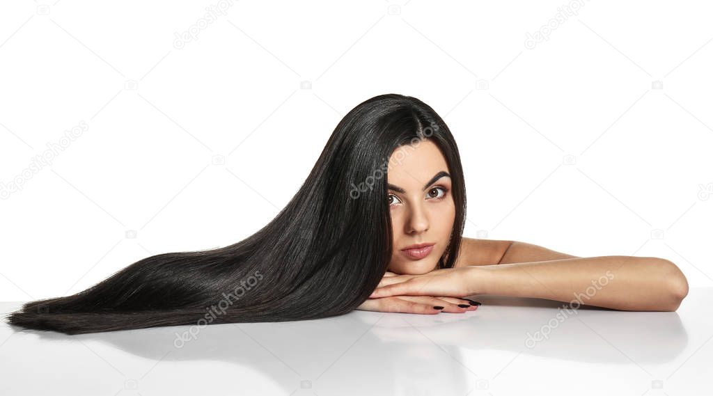 Portrait of beautiful young woman with healthy long hair on white background