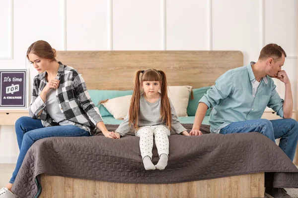 Sad family sitting on bed after quarrel — Stock Photo, Image