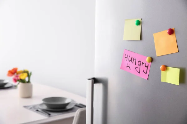 Papers with magnets on fridge door — Stock Photo, Image