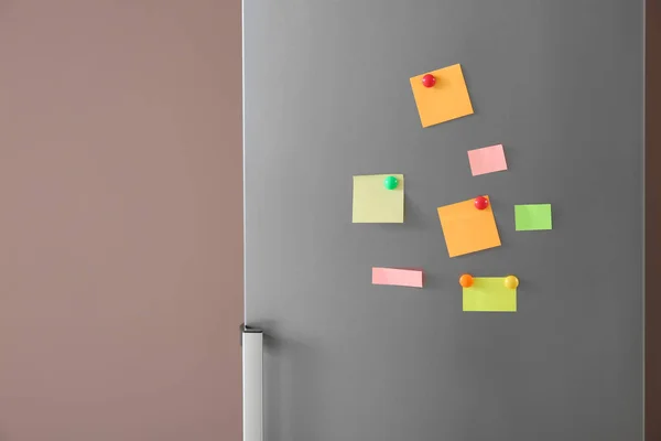 Papers with magnets on fridge door — Stock Photo, Image