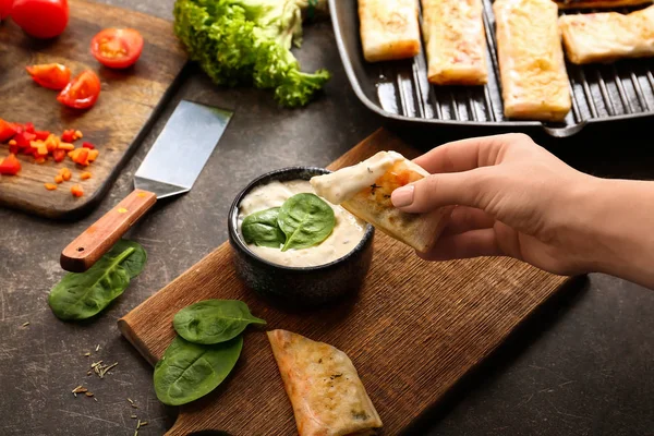 Woman eating tasty spring rolls — Stock Photo, Image