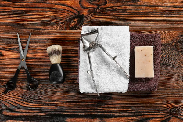 Set of male shaving accessories with hair trimmer on wooden background — Stock Photo, Image