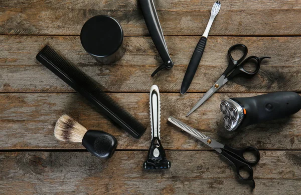 Set of male shaving accessories on wooden background