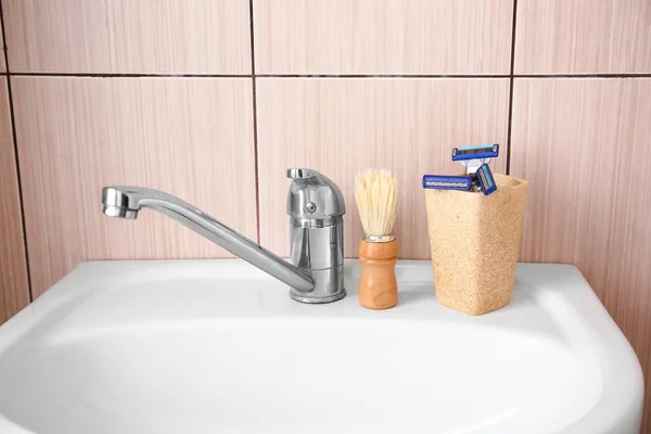 Set of male shaving accessories on sink in bathroom — Stock Photo, Image