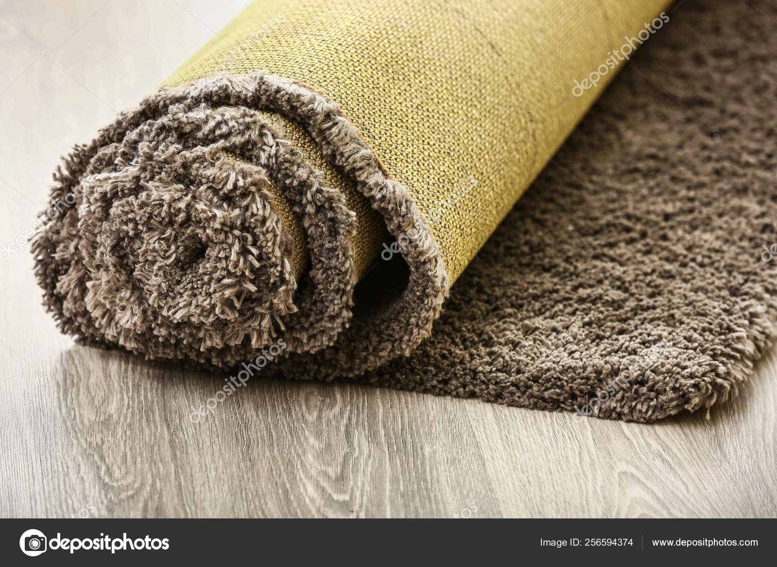 Rolled carpet on floor in room — Stock Photo © serezniy 256594374