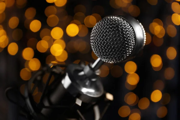 Microphone against dark background with defocused lights — Stock Photo, Image