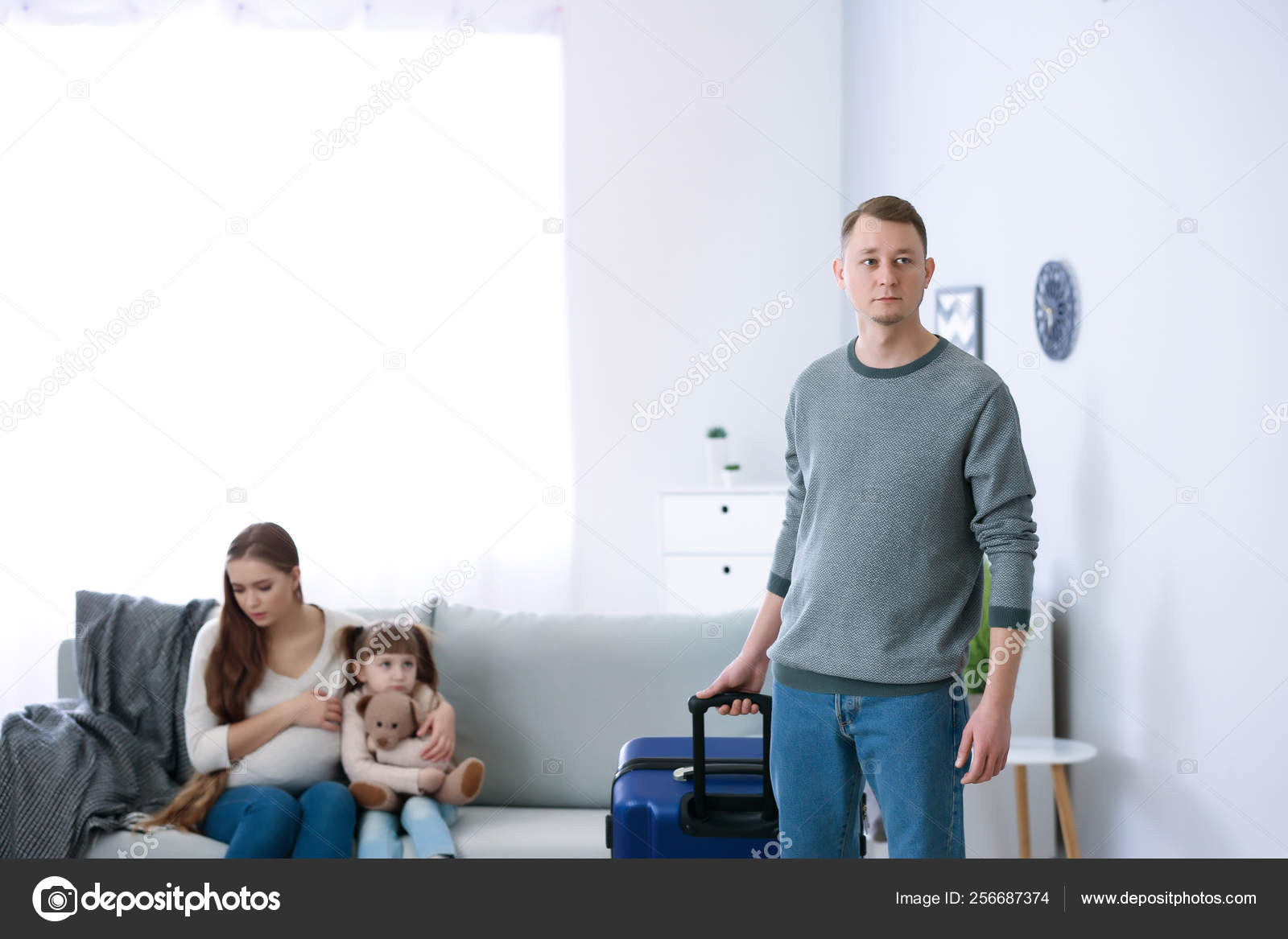 Man with suitcase leaving his family Stock Photo by ©serezniy 256687374