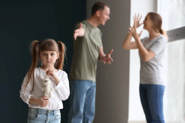 Sad little girl and her quarreling parents at home — Stock Photo, Image