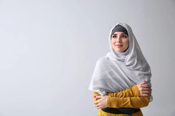 Beautiful Muslim woman on light background — Stock Photo, Image