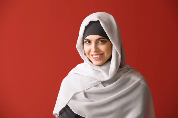 Beautiful Muslim woman on color background — Stock Photo, Image