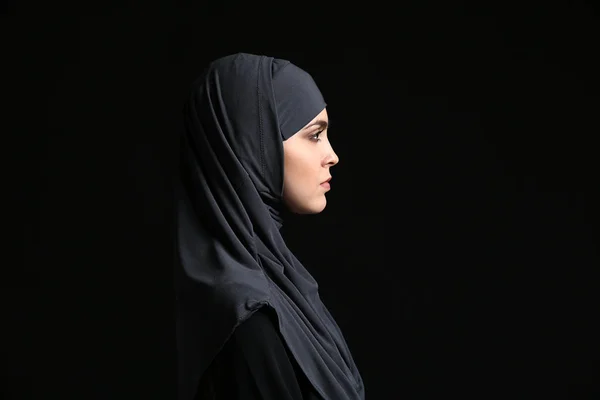 Schöne muslimische Frau auf dunklem Hintergrund — Stockfoto