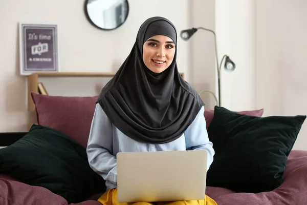 Muslim woman working on laptop at home — Stock Photo, Image