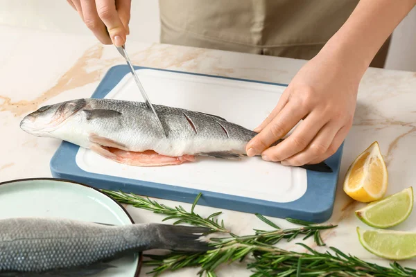 Woman preparing tasty fresh fish — Stock Photo, Image