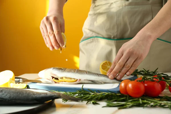 Woman preparing tasty fresh fish — Stock Photo, Image