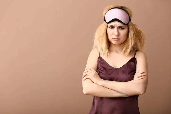 Displeased woman with sleep mask on color background — Stock Photo, Image