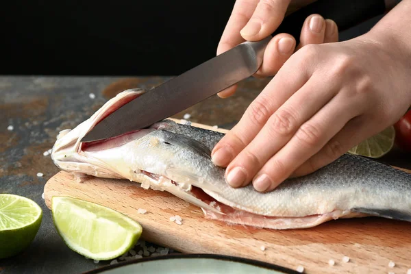 Woman preparing tasty fresh fish — Stock Photo, Image