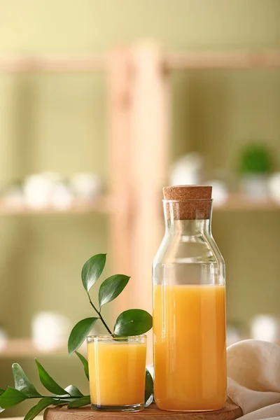 Bottle and glass of tasty orange juice on table — Stock Photo, Image